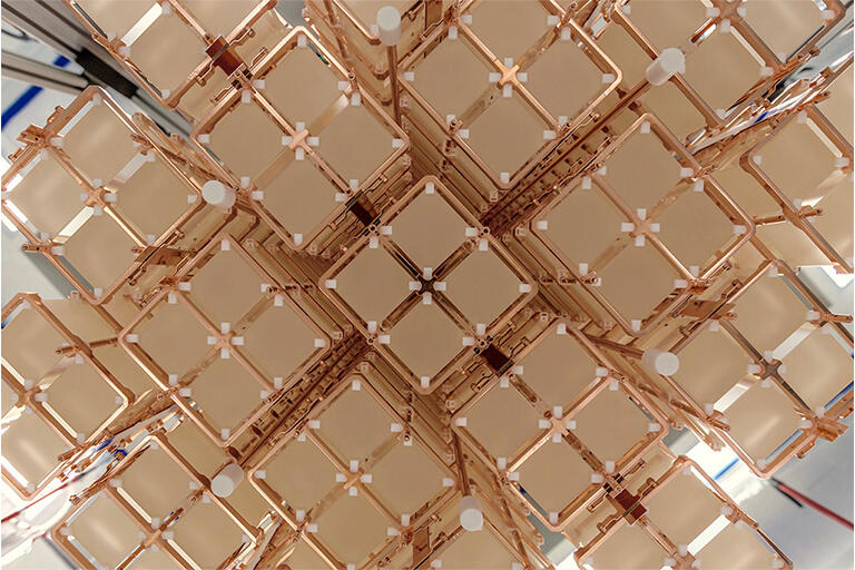The CUORE detector has 19 copper-framed “towers” that each house a matrix of 52 cube-shaped crystals.